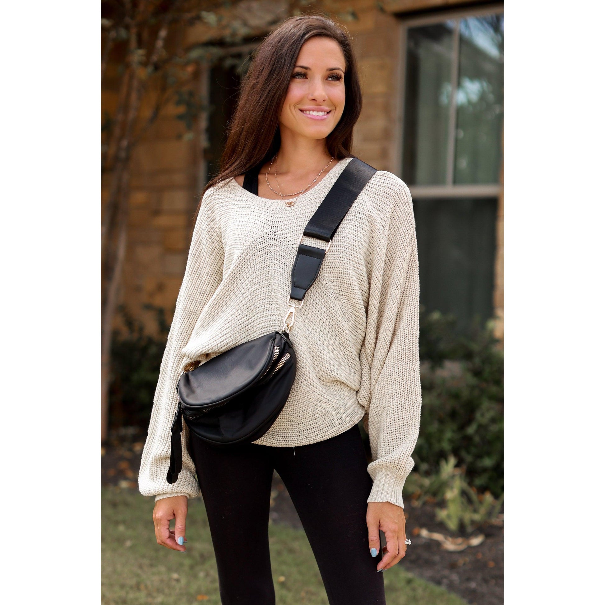 Women's sling bag with zipper closure and adjustable strap