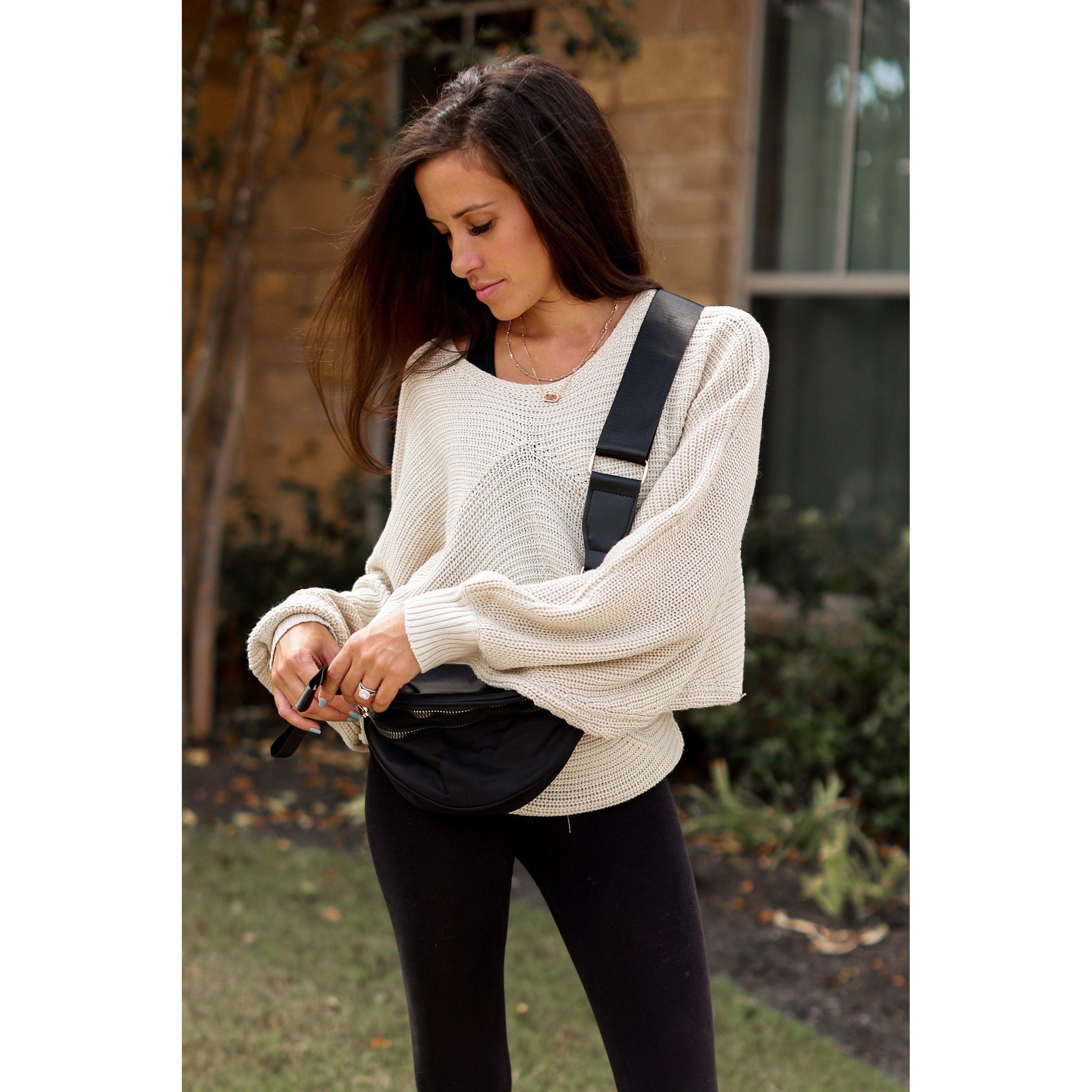 Women's sling bag with zipper closure and adjustable strap