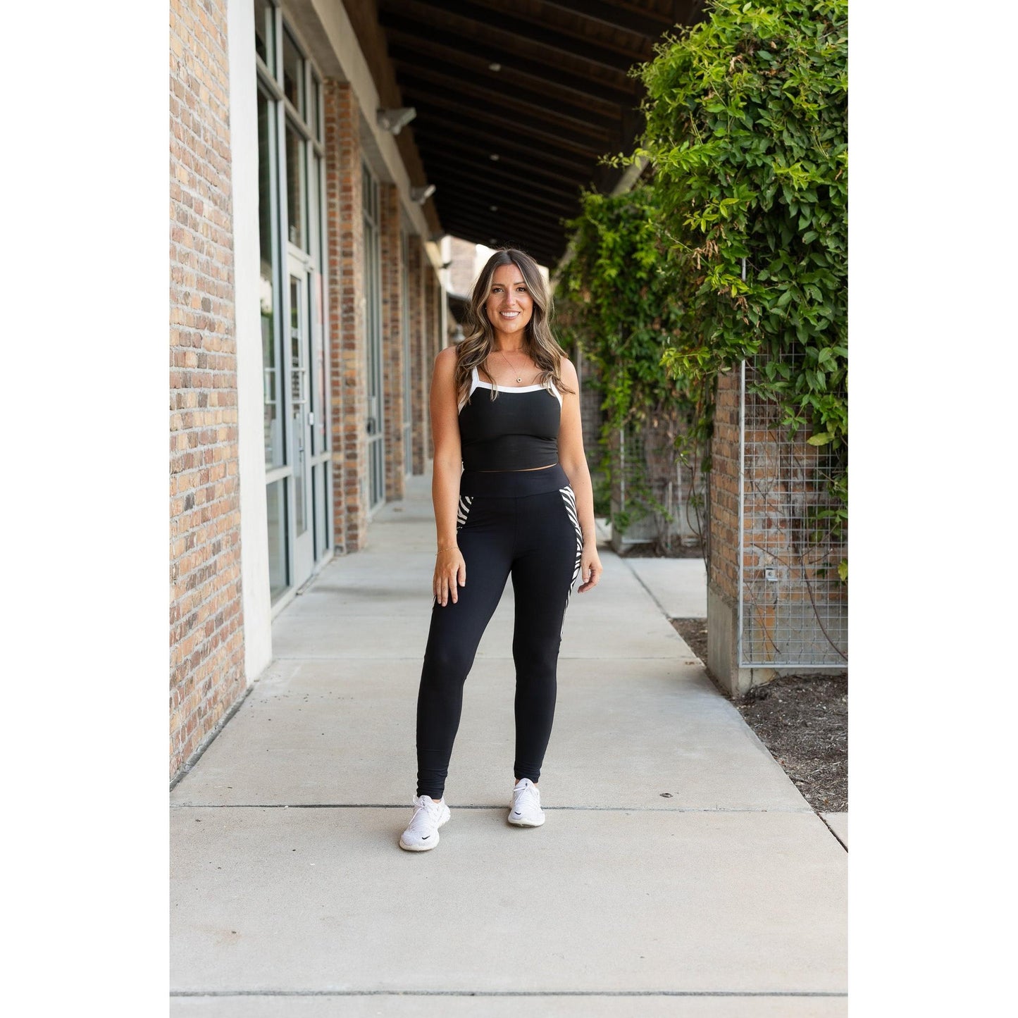 Julia Rose Carolina Cow Print Panel Leggings women’s boutique leggings front view, Woman wearing Julia Rose Carolina leggings with cow print panel detail